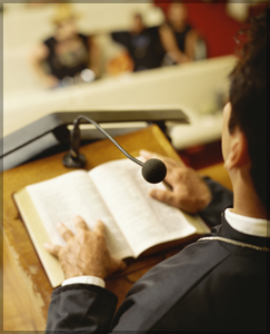 Man standing behind a pulpit in a church.